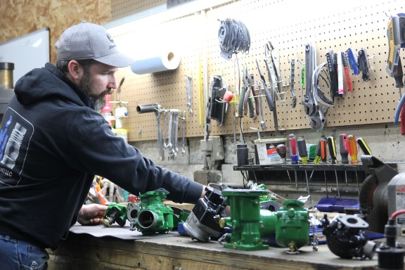 teacher and student working on car